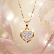 Gold heart-shaped pendant necklace with diamonds on a soft pink background